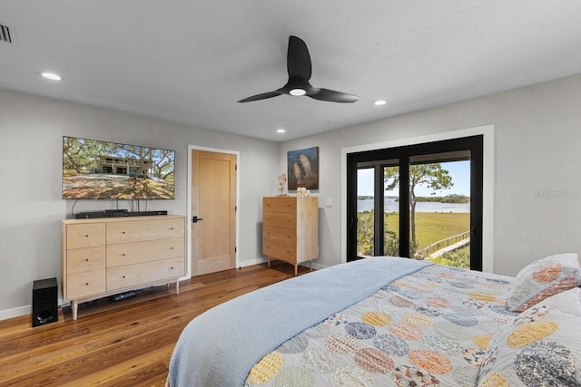 bedroom with hardwood / wood-style floors, access to outside, and ceiling fan