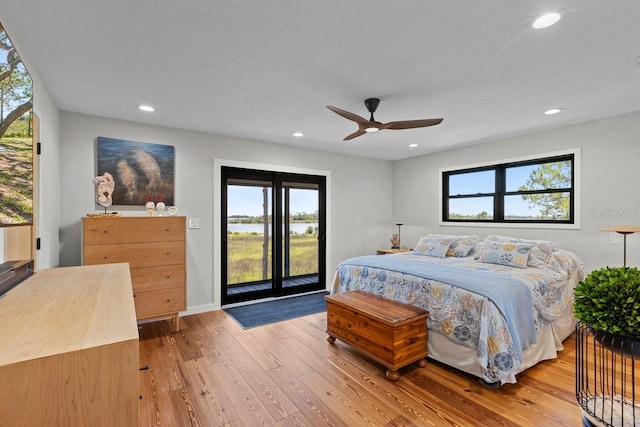 bedroom with access to exterior, light hardwood / wood-style floors, and ceiling fan