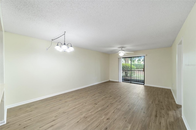 unfurnished room featuring ceiling fan with notable chandelier, a textured ceiling, and light hardwood / wood-style floors