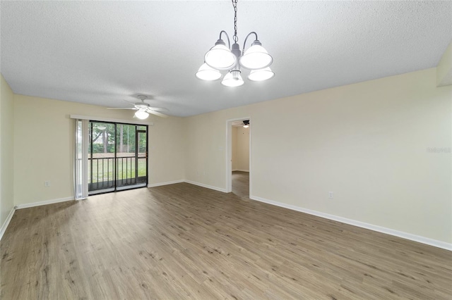 unfurnished room with a textured ceiling, light hardwood / wood-style flooring, and ceiling fan with notable chandelier