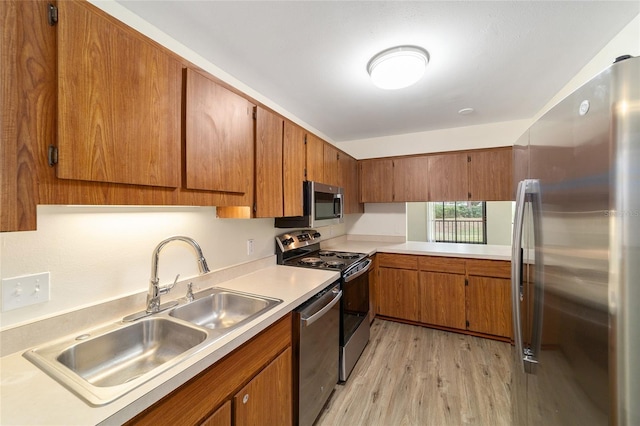 kitchen featuring light wood-type flooring, sink, and appliances with stainless steel finishes