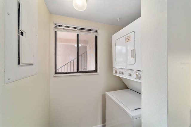 clothes washing area featuring stacked washer / dryer