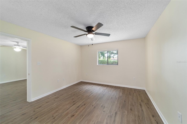 empty room featuring a textured ceiling, dark hardwood / wood-style flooring, and ceiling fan