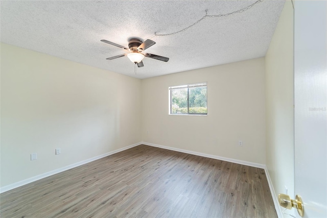 spare room with ceiling fan, a textured ceiling, and light hardwood / wood-style flooring