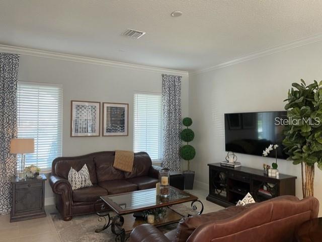 tiled living room with crown molding