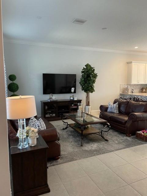 tiled living room with crown molding