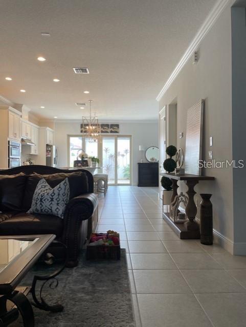 tiled living room with ornamental molding