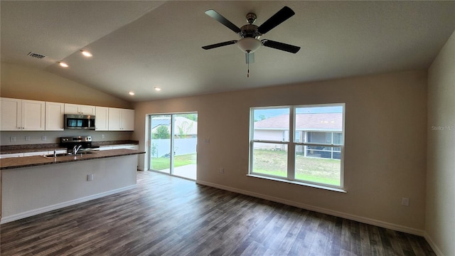 kitchen featuring dark hardwood / wood-style floors, stainless steel appliances, white cabinets, and lofted ceiling