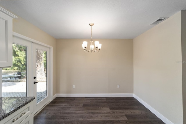 interior space with a chandelier, french doors, and dark hardwood / wood-style floors