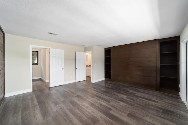 unfurnished bedroom with dark hardwood / wood-style floors