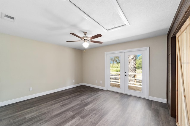 empty room with ceiling fan, dark hardwood / wood-style flooring, a textured ceiling, and french doors