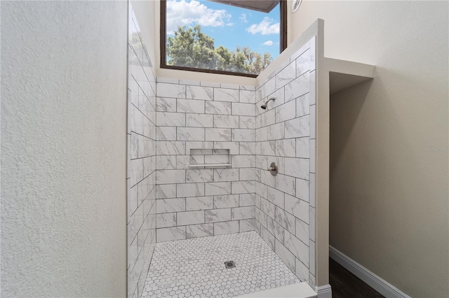 bathroom with tiled shower