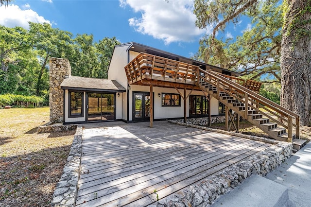 rear view of property featuring a wooden deck