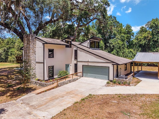 view of front of home with a carport and a garage