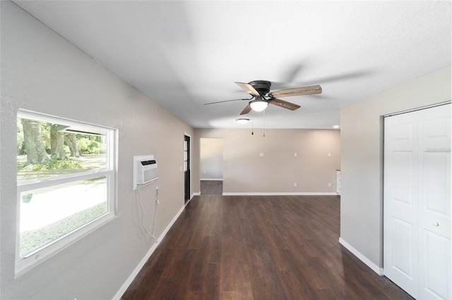 corridor featuring a wall mounted air conditioner and dark hardwood / wood-style flooring