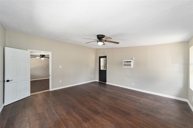 empty room featuring an AC wall unit, ceiling fan, and dark hardwood / wood-style floors