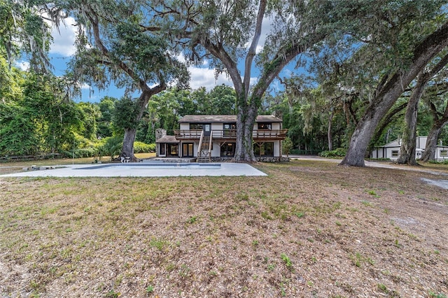 view of yard featuring a patio and a wooden deck