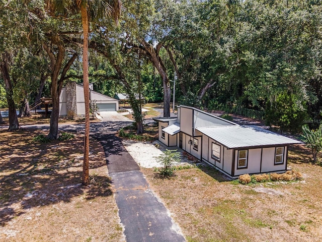 view of home's exterior featuring a garage and an outdoor structure