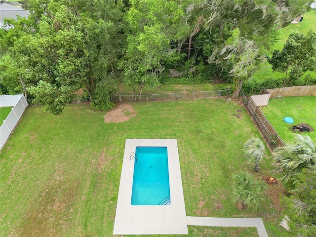 view of swimming pool with a lawn