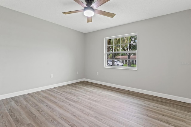 spare room with ceiling fan and light hardwood / wood-style flooring