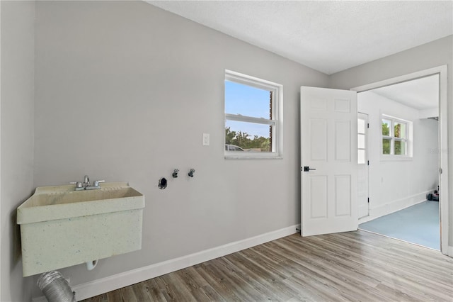 entryway featuring sink, a textured ceiling, and hardwood / wood-style flooring