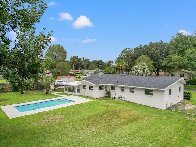 rear view of property featuring a patio and a lawn