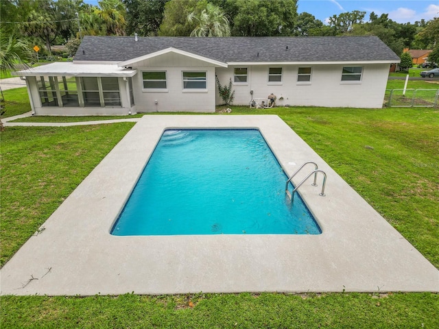 back of house featuring a patio, a yard, and a sunroom