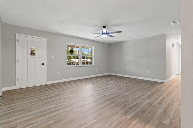 interior space featuring a textured ceiling, ceiling fan, and light hardwood / wood-style flooring