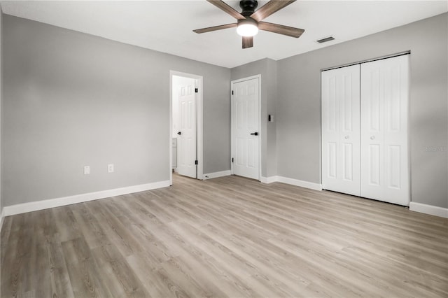 unfurnished bedroom featuring ceiling fan, light hardwood / wood-style flooring, and a closet