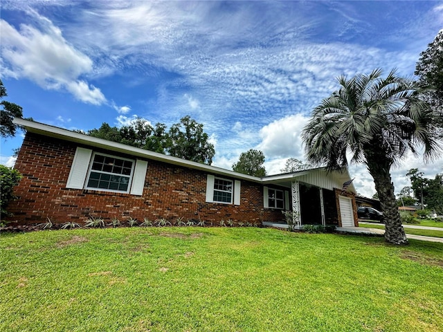 ranch-style home with a front lawn and a garage