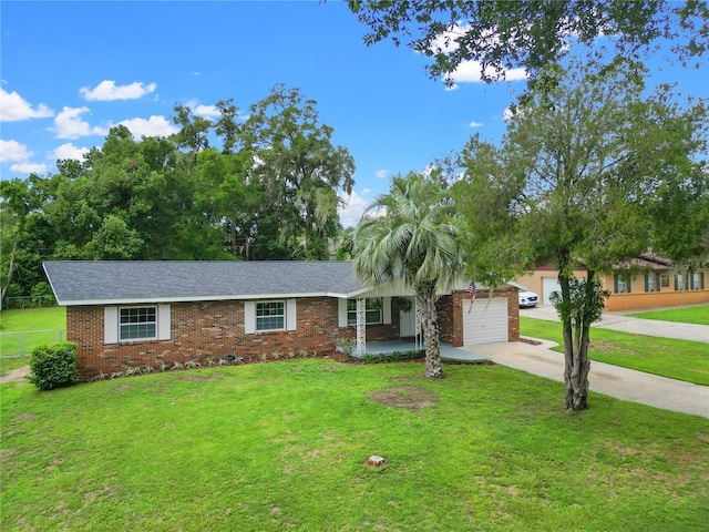 ranch-style home with a front yard and a garage