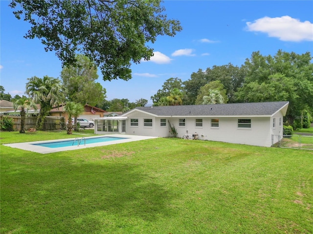 back of property featuring a patio and a yard