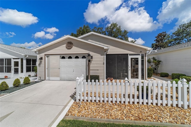 single story home with a sunroom and a garage