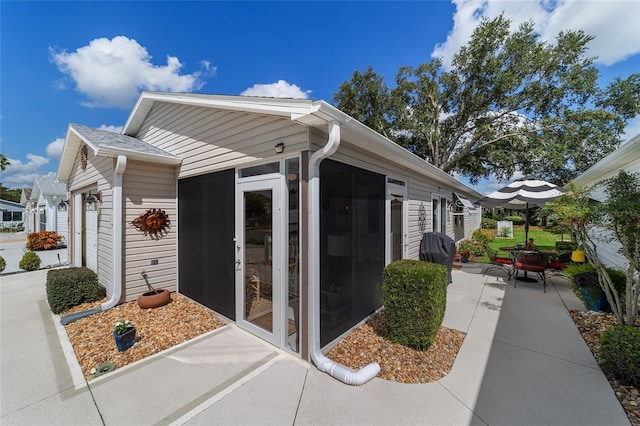 view of property exterior with a patio and a garage