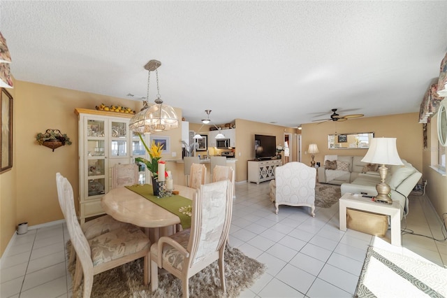 dining space with light tile patterned floors and ceiling fan