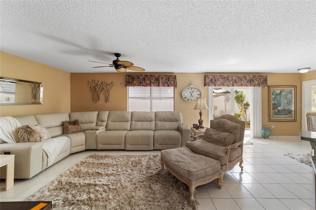 tiled living room featuring a textured ceiling and ceiling fan