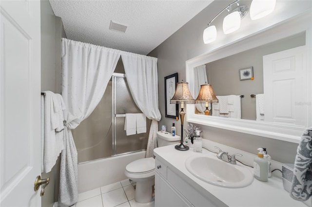 full bathroom with combined bath / shower with glass door, tile patterned floors, vanity, a textured ceiling, and toilet