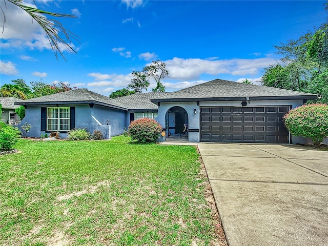 ranch-style home featuring a front lawn and a garage