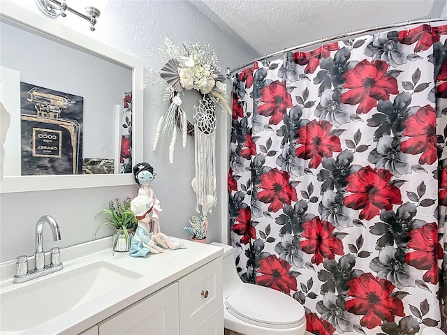 bathroom with a shower with curtain, vanity, toilet, and a textured ceiling