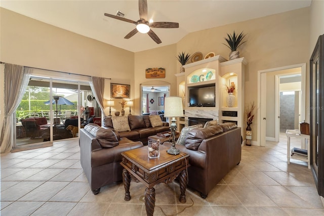 tiled living room with ceiling fan and vaulted ceiling