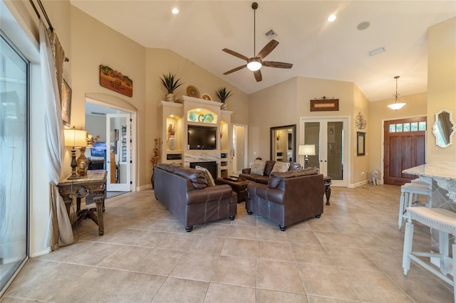 living room with light tile patterned flooring, high vaulted ceiling, ceiling fan, and french doors