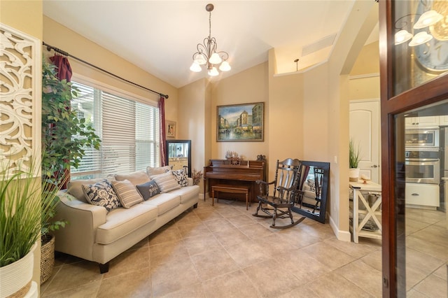 living room with light tile patterned floors, vaulted ceiling, and a notable chandelier