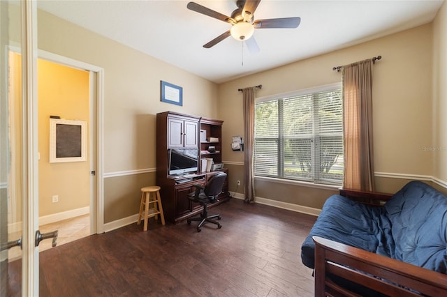 office with dark wood-type flooring and ceiling fan