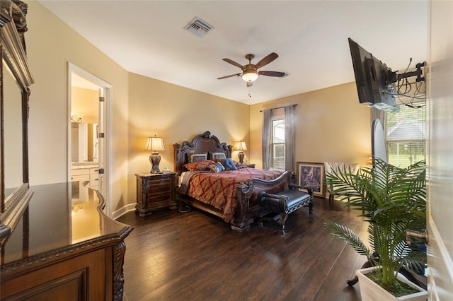 bedroom featuring dark wood-type flooring, connected bathroom, and ceiling fan