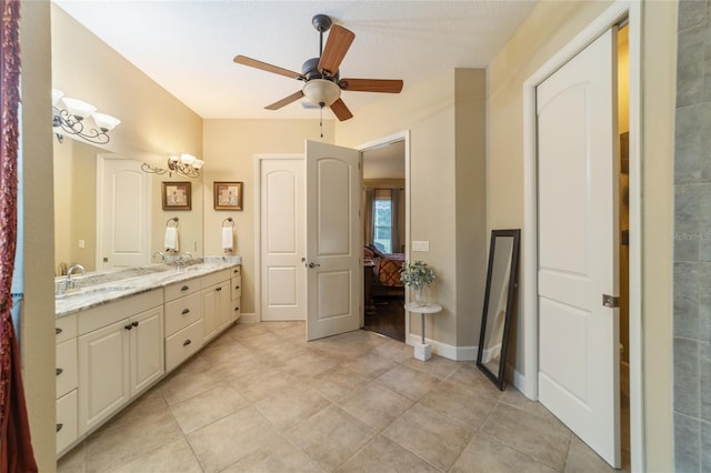 bathroom featuring ceiling fan with notable chandelier and vanity