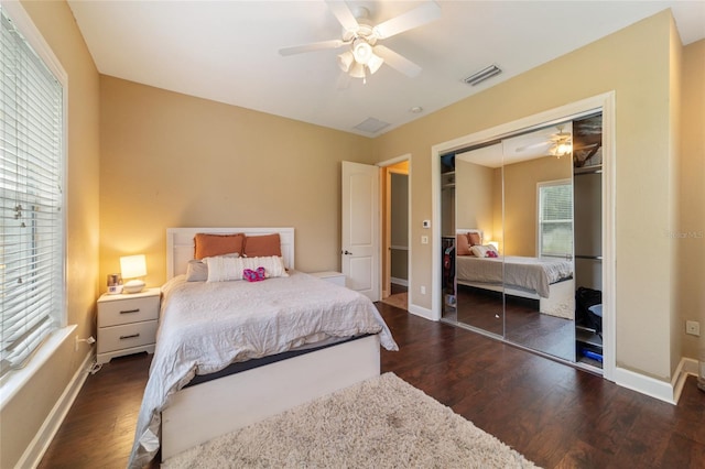 bedroom with a closet, ceiling fan, and dark hardwood / wood-style flooring