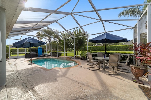 view of swimming pool with a patio area and a lanai