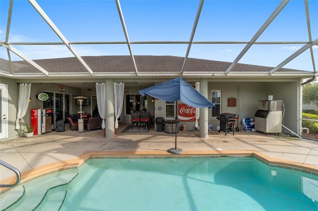 view of swimming pool featuring a patio area and a lanai