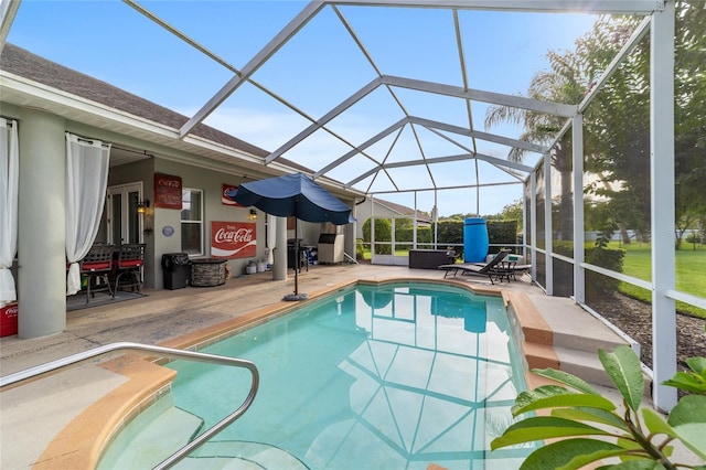 view of swimming pool featuring a patio and a lanai