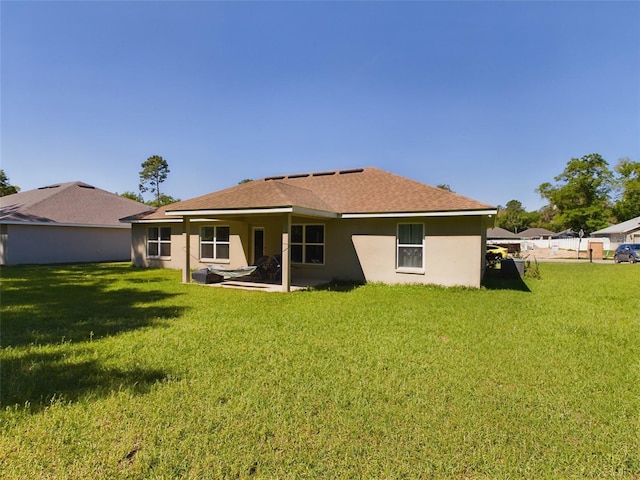 rear view of house featuring a lawn